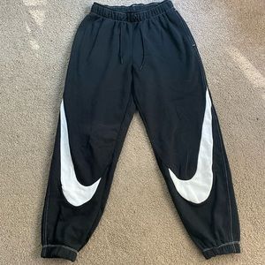 Black sweatpants with white Nike swoosh. Womens size xs